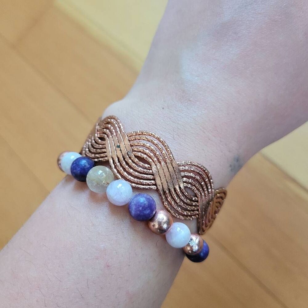 Set of two bracelets copper colored wavy bangle and stretchy beaded multicolored